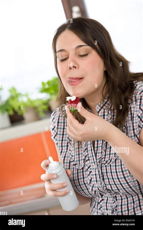 Plus Size Woman With Whipped Cream On Strawberry Licking Lips Stock