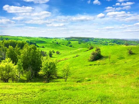 Picturesque Hilly Landscape With Bright Blue Cloudy Sky