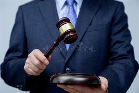 Male Businessman Holding A Gavel In Hand Justice And Auction Concept
