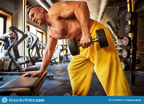 Hard Working Male Athlete Doing Physical Exercises At Gym Stock Photo