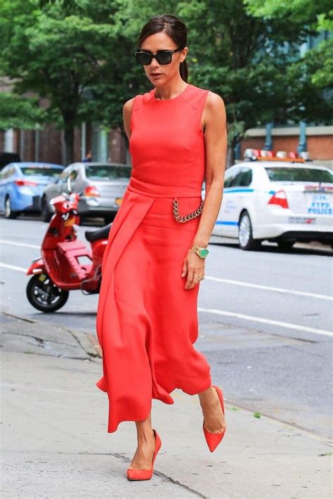 victoria beckham in a coral red dress from her autumn winter 14