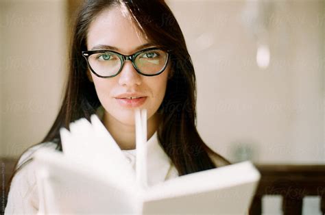 Young Woman Wearing Glasses Looking At Camera By Stocksy Contributor