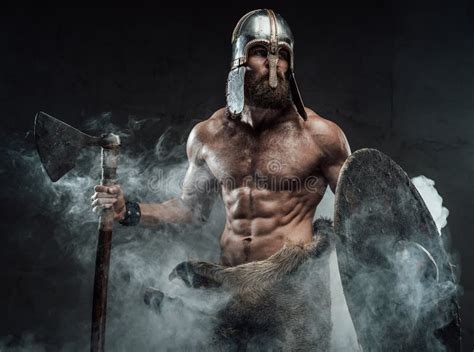 Armoured And Naked Viking Posing With Axe And Shield In Smoke Stock