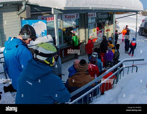 Long Queue To Get The Lift Ticket Skier And Ski Tour Walker Take The