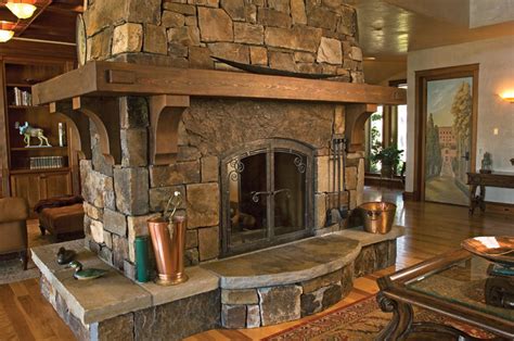 Close Up View Of Freestanding Stone Fireplace With Wrap Around Wood