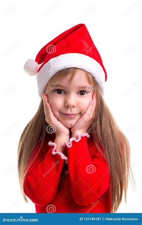 Happy Coquettish Christmas Girl Wearing A Santa Hat Isolated Over A