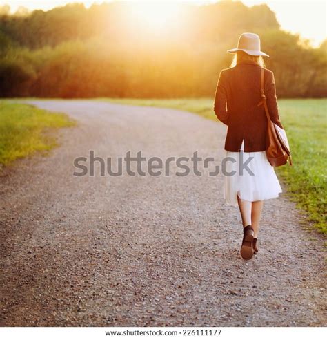 Girl Walking Down Road Among Fields Stock Photo Edit Now 226111177