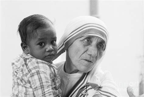 Mother Teresa Holding Young Boy 1 By Bettmann