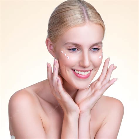 Premium Photo Personable Woman Applying Moisturizer Cream On Her Face For Perfect Skin