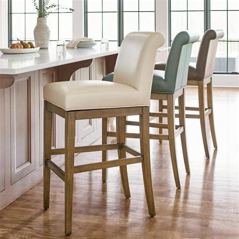 A curved wood frame, chrome footrest and swivel seat are smartly juxtaposed by a traditional high cushioned backrest and seat. Penelope Lowback Swivel Bar & Counter Stool in 2020 ...
