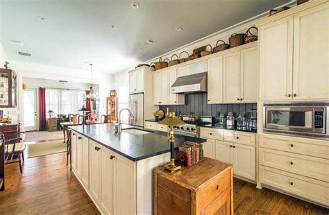 Decorating Ideas for the Space Above Kitchen Cabinets ... From unique cabinetry solutions to little tricks, these ideas just might help you feel like you've doubled your kitchen's square footage.