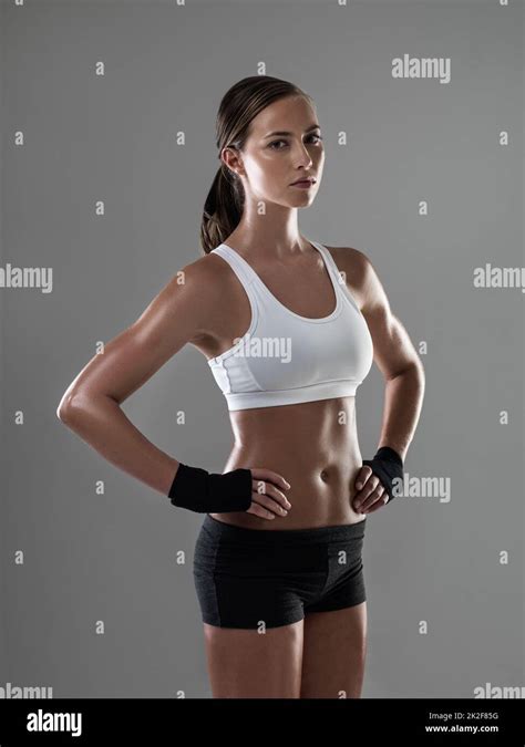 feeling strong inside and out shot of an athletic woman in workout clothes standing with her