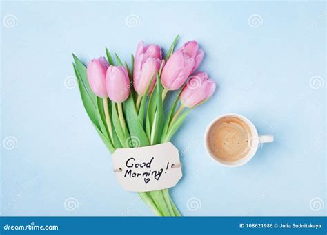 Coffee Cup Pink Tulip Flowers And Note Good Morning On Blue Table Top