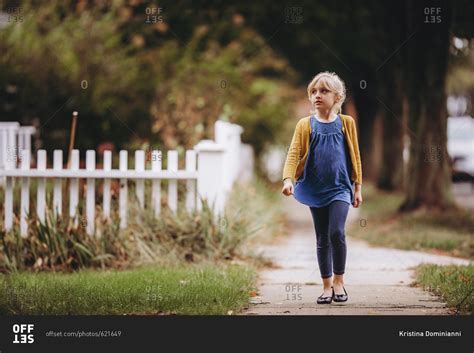 Babe Girl Walking Down The Sidewalk Stock Photo OFFSET