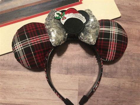 There Is A Mouse Ears Headband With A Santa Clause On It And A Red