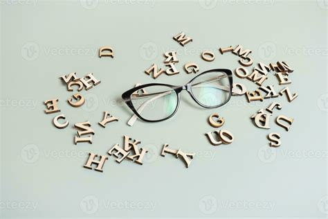 Eyeglasses On Pastel Green Background With Wooden Letters Vision Testoptical Store Concept