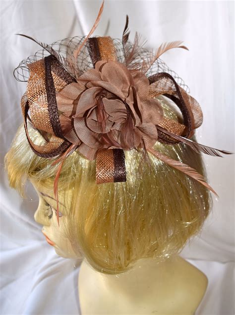 two shades of brown floral fancy fascinator with feathers and bird cage bird cage design