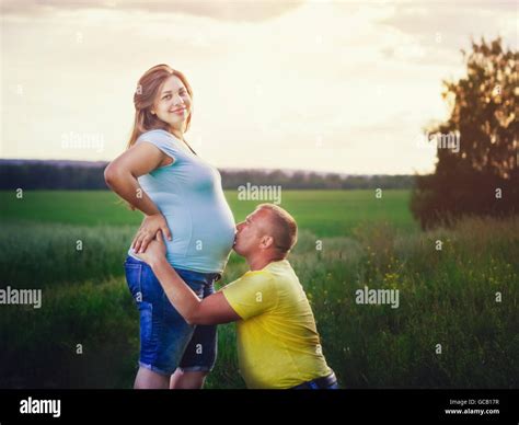 Man Kissing Pregnant Belly Of His Wife Outdoors Stock Photo Alamy