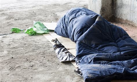 Homeless Man Sleeping In Sleeping Bag On Cardboard Sub Zero Mission