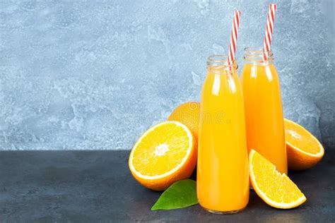 Fresh Orange Juice In The Glass Bottle Fresh Oranges On Dark Table