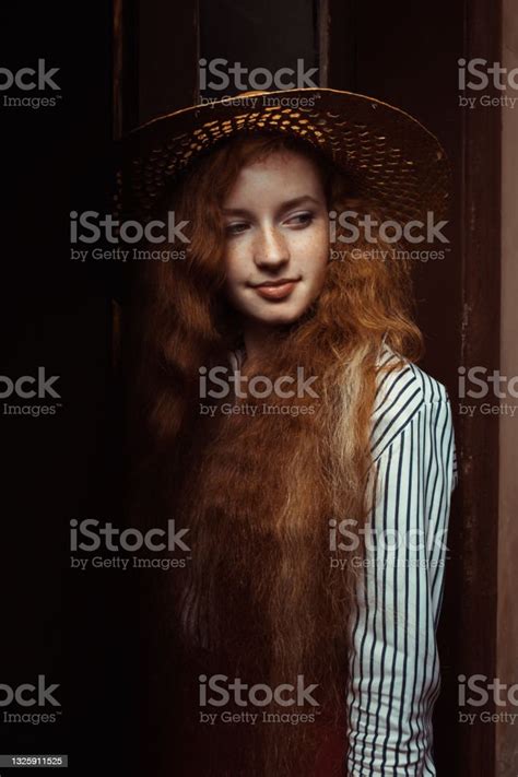 Beautiful Ginger Model With Freckles In Straw Hat Posing In Old Passage