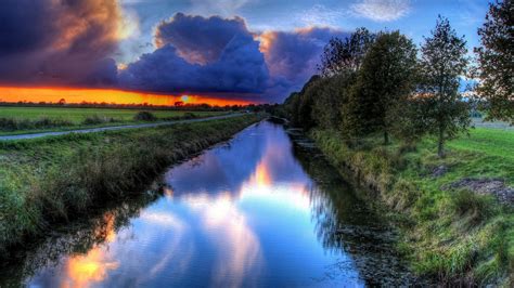 Enjoy and share your favorite beautiful hd wallpapers and background images. Sunset Orange Sky, Dark Clouds Channel Water Path Trees Hd ...