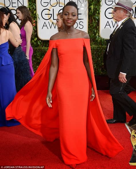 Lupita Nyongo Is Striking In A Red Ralph Lauren Gown At The 2014