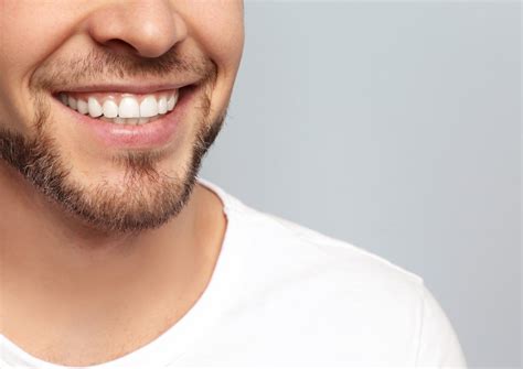Young Man With Beautiful Smile On White Background Teeth Whitening
