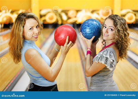 Two Women Hold Balls And Smile In Bowling Club Stock Image Image Of