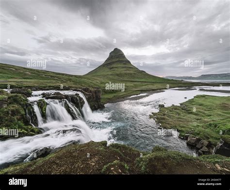 Kirkjufellsfoss Waterfall And Kirkjufell Mountain Near The City Of