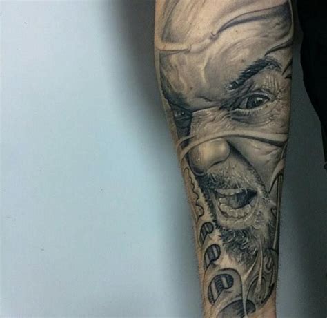 A Mans Leg With A Tattoo On It That Has An Image Of A Clown