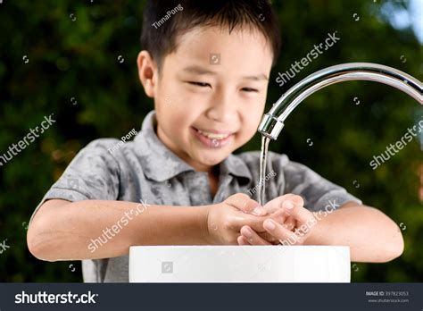 Close Up Kid Hand Under The Brand New Faucet Stock Photo 397823053