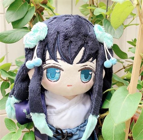 A Stuffed Animal Doll With Blue Eyes And Black Hair