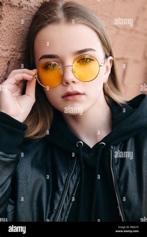 Beautiful Fashionable Kid Girl In Yellow Sunglasses In City Stock Photo