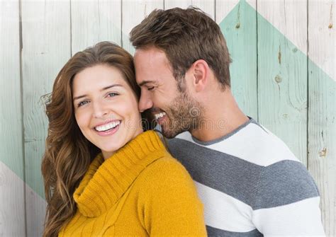 Couple Embracing Each Other Against Wooden Background Stock Image