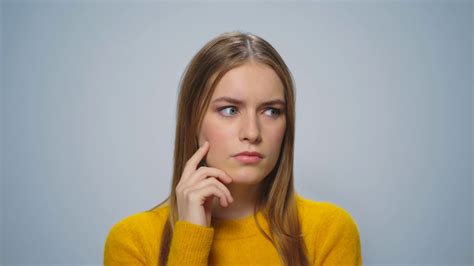 Portrait Of Beautiful Woman Thinking Problem Solution On Grey