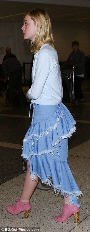 Elle Fanning Wears Blue Skirt And Pink Boots As She Jets Out Of Lax