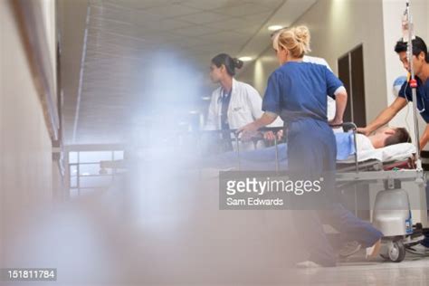 Doctors And Nurses Wheeling Patient In High Res Stock Photo Getty Images