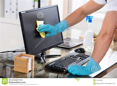Close Up Of A Janitor Cleaning Computer Screen Stock Photo