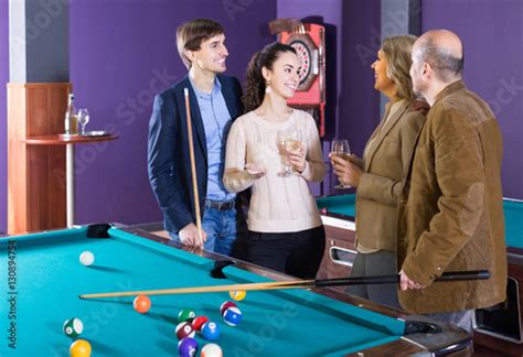 Mature And Young Couples Hanging Out In Billiard Club Together Kaufen