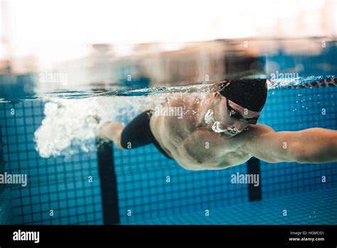 Underwater Shot Of Pro Male Swimmer In Action Inside Swimming Pool