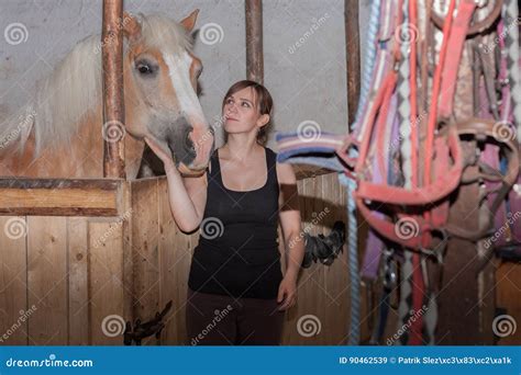 Young Woman Stroking Her Horse In Stable Stock Image Image Of
