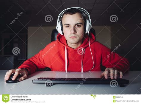 Young Man In Headphone Uses A Computer Gamer Plays Games On The