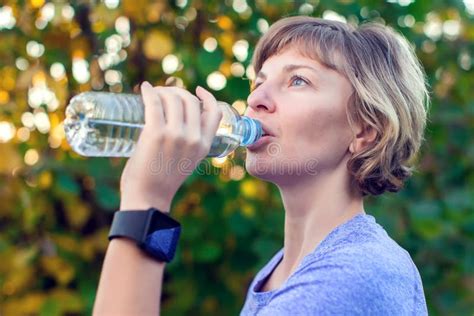 Portrait Of Happy Fitness Woman Drinking Water After Workout Out Stock