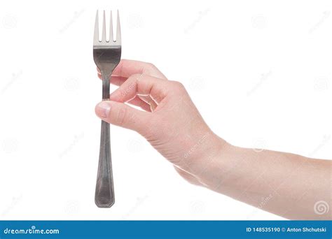 Hand Holding A Silver Fork On An Isolated White Background Stock Photo