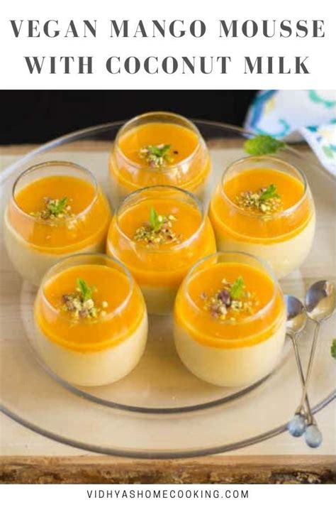 Four Glasses Filled With Mango Mousse Sitting On Top Of A Glass Platter