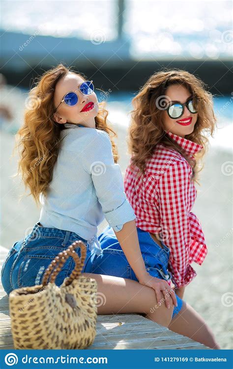 Two Attractive Girls Cheerful Best Friends Having Fun At Beach Party Wearing Summer Outfit