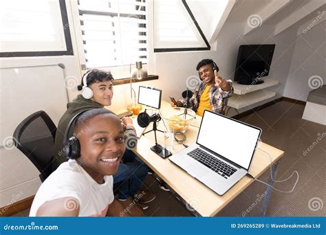 Image Of Happy Diverse Teenage Boys With Headphones And Laptops With