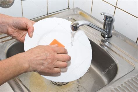 Washing Plate In The Kitchen — Stock Photo © Djemphoto 1080123
