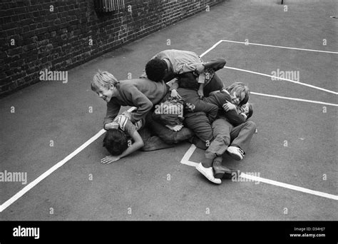 Primary School Children Boys Play Fighting Playground Games Rough And